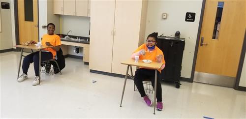 Two students sitting at desks 